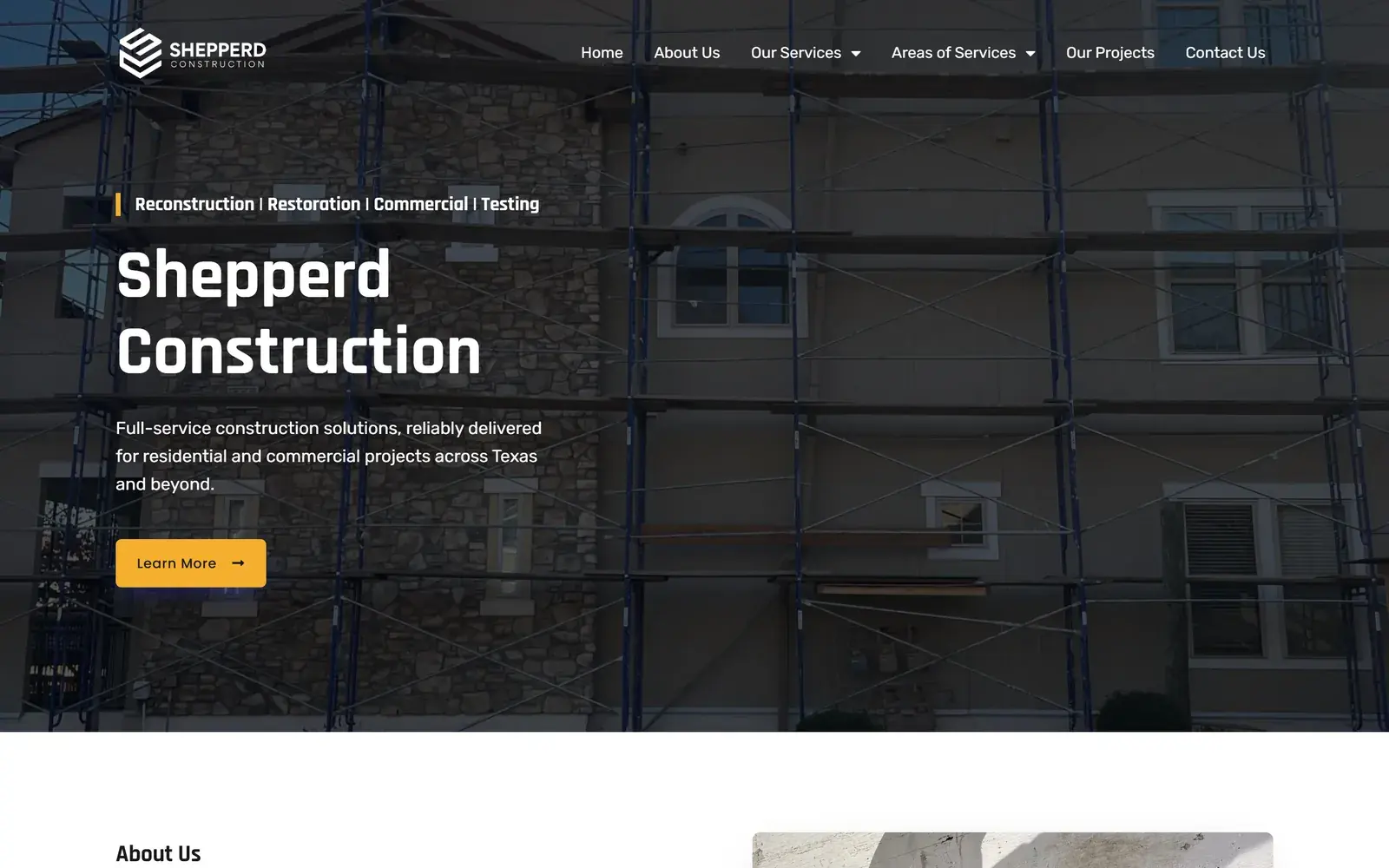 Shepperd Construction homepage on desktop, with the tagline Reconstruction, Restoration, Commercial, Testing, the headline Shepperd Construction, a yellow Learn More button and a background photo of scaffolding along a stone and stucco building